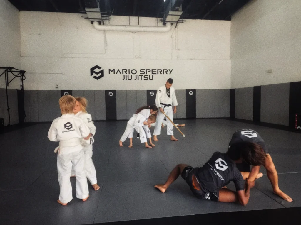 Children learning Jiu-Jitsu under professional guidance at Mario Sperry Academy